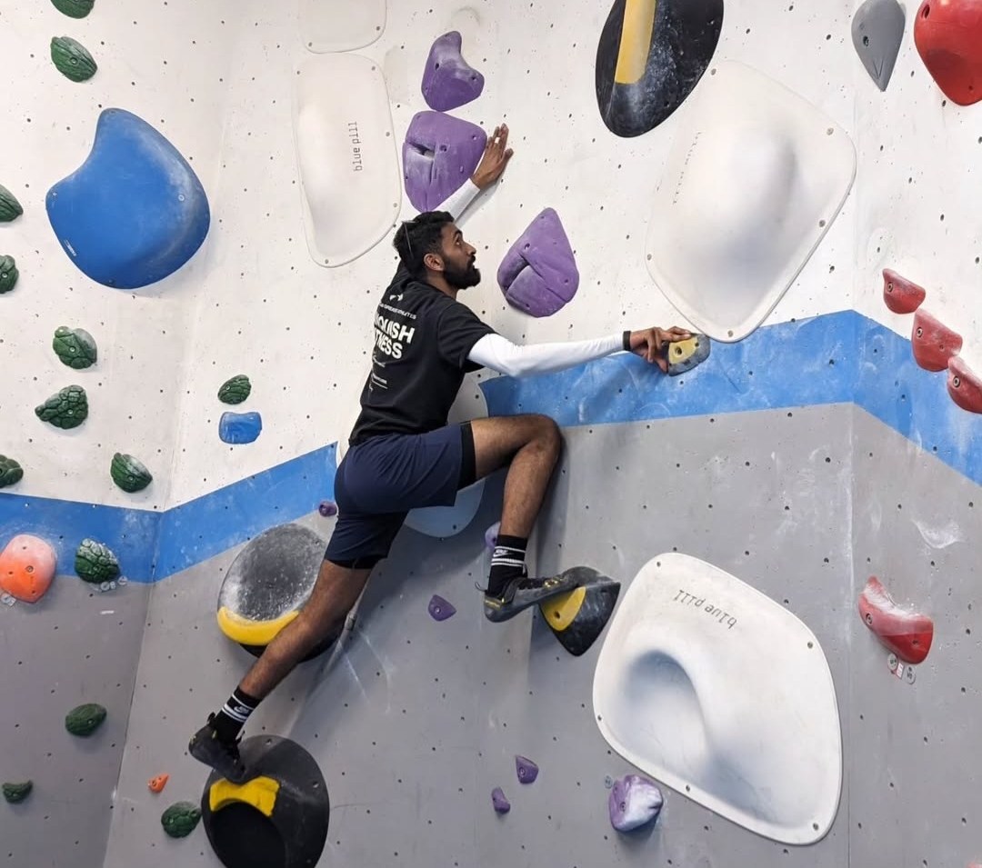 Shane bouldering at a climbing wall